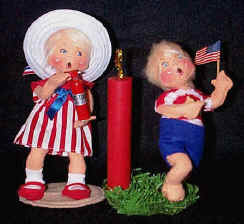 Sue Coffee Exclusives Patriotic Girl helping a boy with his firecracker