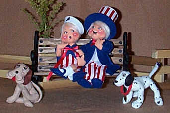 Annalee Sue Coffee Exclusives Patriotic Boy and Girl sitting together on a park bench with thier pet dog.